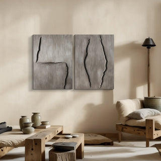 Two abstract wooden sculptures on a beige wall with minimal decor.